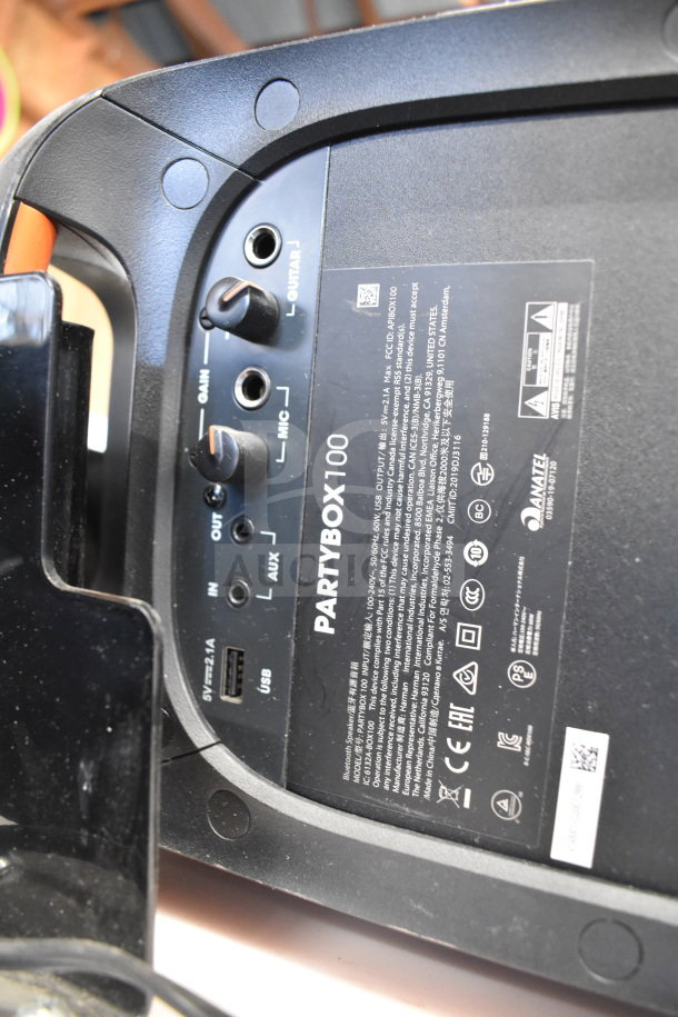 JBL PartyBox 100 speaker's input panel with USB, AUX, MIC, GAIN ports visible. Black casing, label details, good condition.