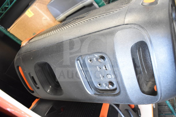 JBL speaker with control panel, featuring gain, AUX, and USB ports. Visible wear on the plastic casing.