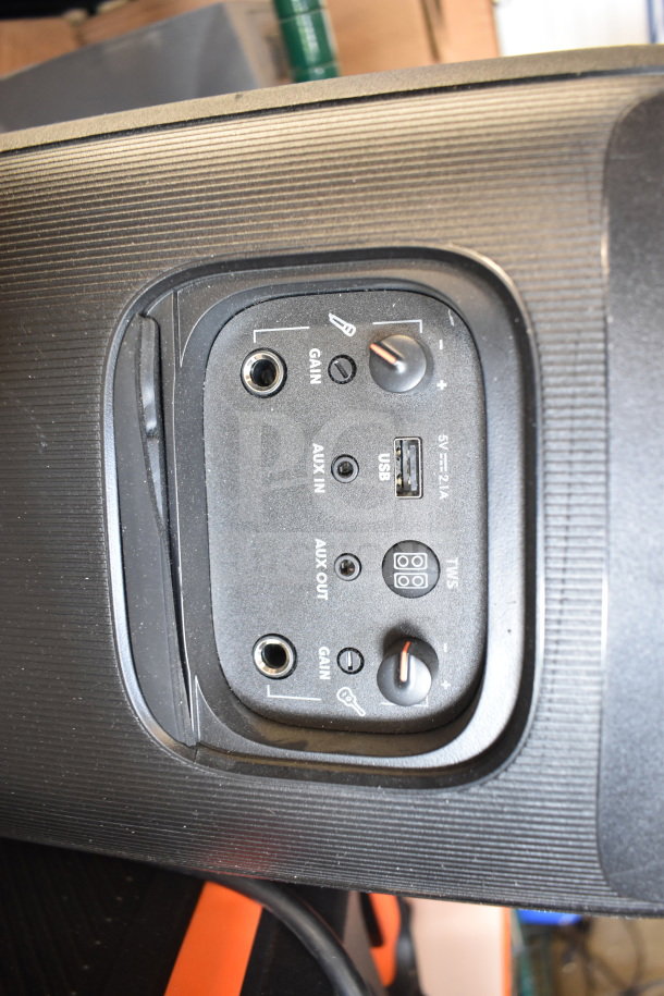 JBL speaker with AUX in/out, USB port, gain controls, and TWS button. Features ribbed texture and appears in good condition.