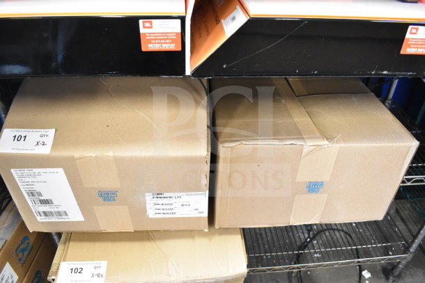 Two Sensormatic AMS-9060 Surveillance Controllers in unopened boxes, item label indicating lot 101, quantity 2.