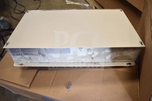 Sensormatic AMS-9060 surveillance controller, used condition, visible labels with specifications, ready for auction.