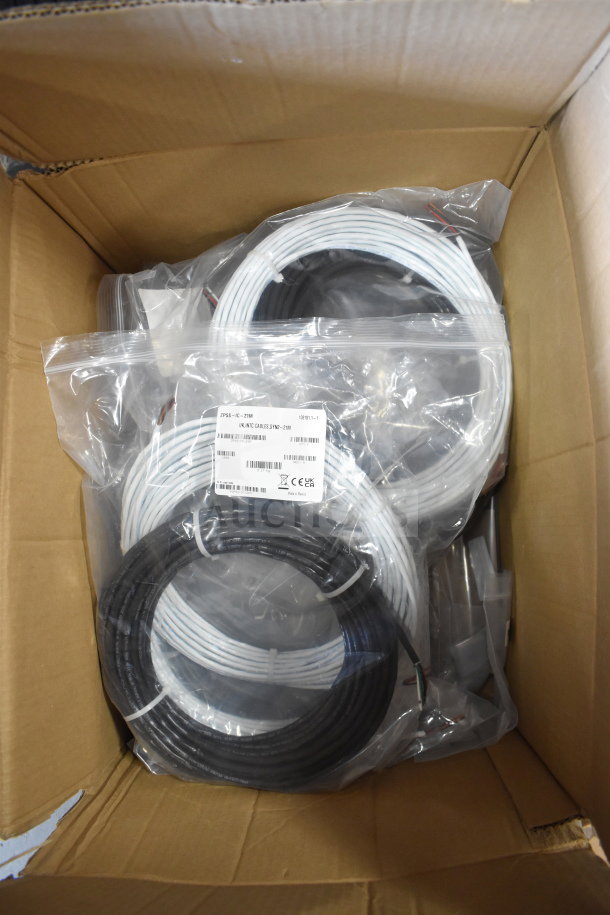 Box containing 8 items including wires, Sensormatic 0352-0659-01 Ethernet isolator. Labeled bags visible.
