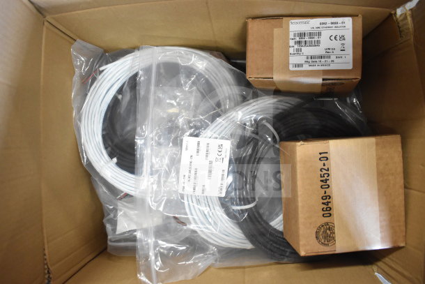 Box of 8 items including Sensormatic 0352-0659-01 Ethernet Isolator, wires. Labels show product details and serial numbers.