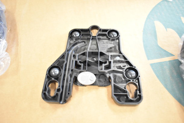 Tellermate Calculator base component, black plastic, unassembled, visible markings, good condition, placed on cardboard.