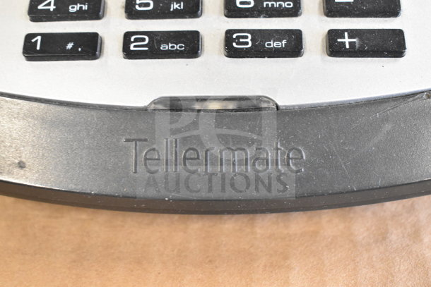 Tellermate calculator with visible numeric keypad, featuring Tellermate branding. Appears in good condition.