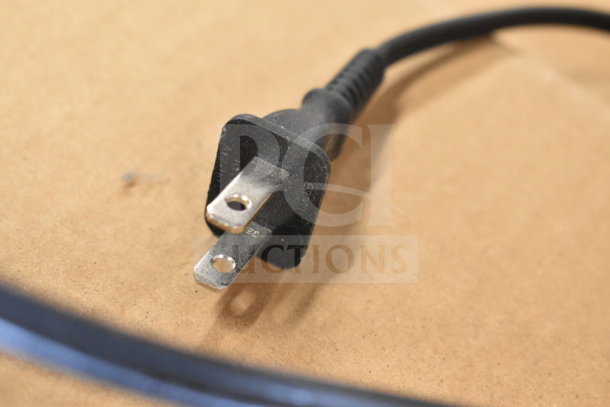 Close-up of a power cord plug, likely used with a Tellermate Calculator. Cord appears in good condition.