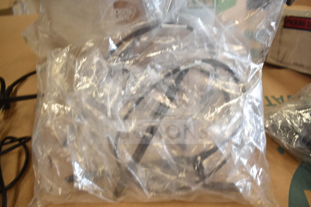 Sealed plastic bag containing cords, potentially related to Tellermate Calculator. Condition: Appears new. No visible labels.