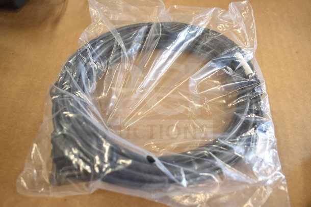 Coiled black cable in plastic packaging, possibly related to Tellermate Calculator, on brown surface.