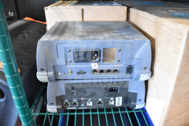Sensormatic ZBSMPROE and other items, stack on shelf; visible ports, power input, and markings. Good condition.