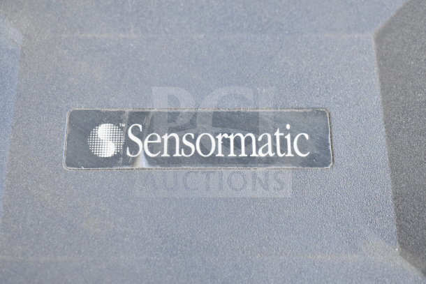 Sensormatic ZBSMPROE label on gray surface, part of a lot of 7 various items. Slightly worn condition.