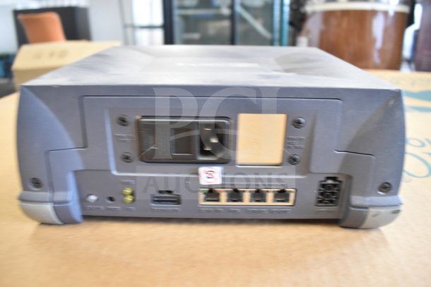 Sensormatic ZBSMPROE device, rear view showing power input and network ports. Used condition, part of 7-item lot.
