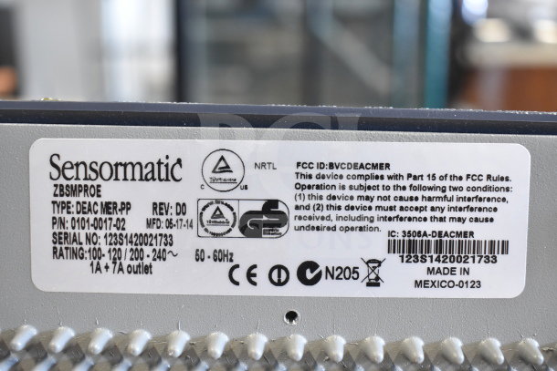 Label on Sensormatic ZBSMPROE device. Type: DEAC MER-PP, Model: 0101-0017-02, MFD: 06-17-14, Serial: 123S1420021733. Made in Mexico.