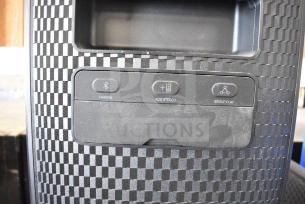 Samsung speaker with textured front panel, featuring Bluetooth pairing, Add Stereo, and Group Play buttons. Store display model.