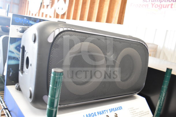 3 store displays with a Samsung speaker and Onn large party speaker, showcasing dual speakers and control panel.