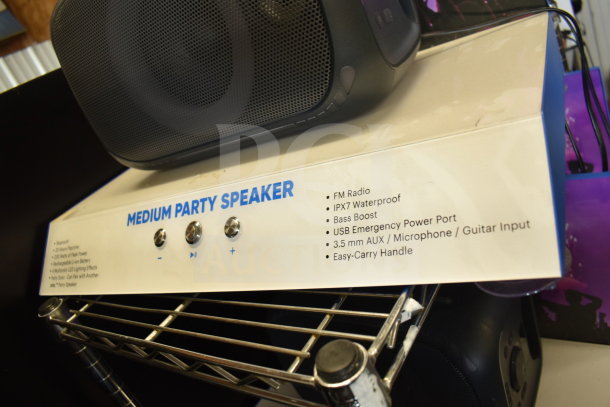 Onn Medium Party Speaker display, featuring FM radio, IPX7 waterproof, bass boost, USB port, and AUX input.