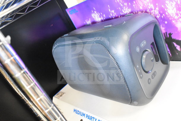 Onn medium party speaker store display, black, showcasing control panel and speaker grille. Good condition. Box labeled "Medium Party Speaker."