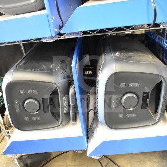Two Onn large party speakers on store display shelves, featuring black design and control panels, in used condition.