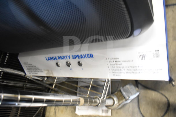 Onn Large Party Speaker store display, featuring FM radio, IPX4 water resistance, bass boost, and multiple input options.