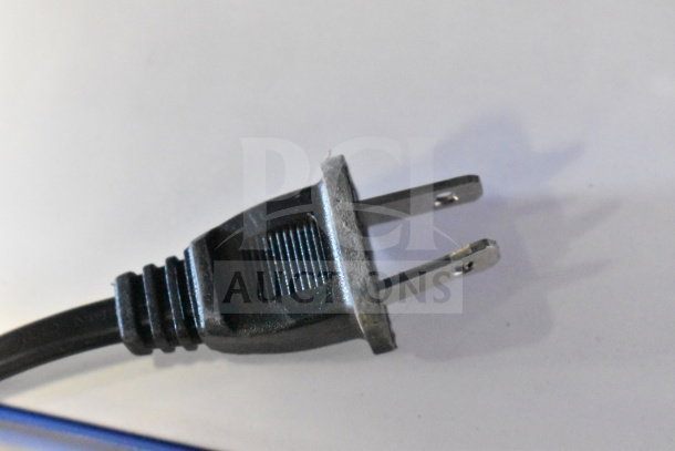 Two-prong power plug on a black cable, close-up view, for Onn Large Party Speaker store display.