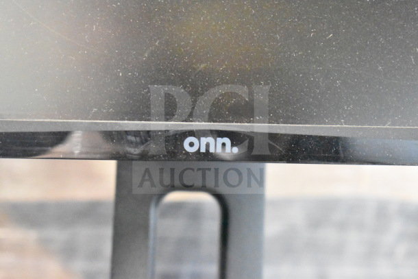 Five monitors including Vizio, Onn, MSI, Samsung; features vary, signs of use. Onn logo visible on one screen.