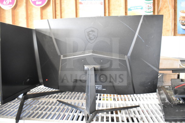 Five monitors from Vizio, Onn, MSi, and Samsung, various models, good condition. Visible MSi logo on one monitor.