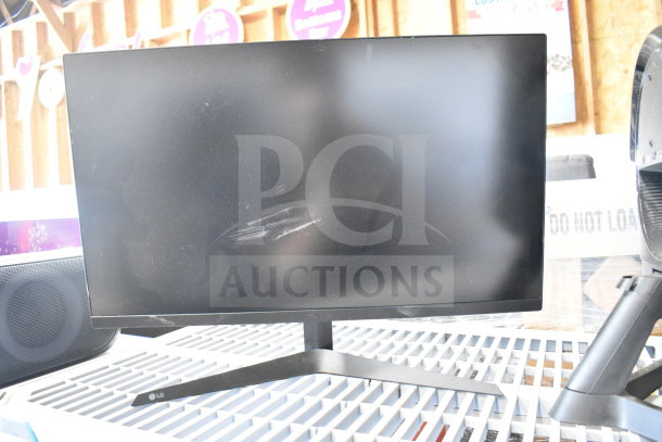 LG monitor with stand, minor screen scratches, auction includes Vizio, Onn, MSi, Samsung models.