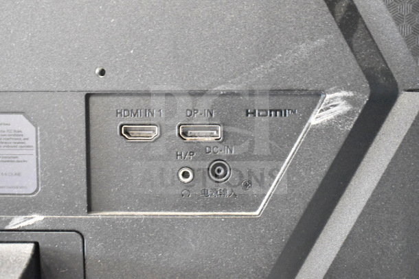 Back panel of a monitor showing HDMI, DP, and DC inputs. Dust visible, indicating moderate wear.