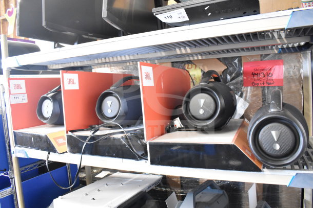 4 JBL Boombox3 speakers on display shelf, new condition, in branded red and black packaging. Tags show retail setup.
