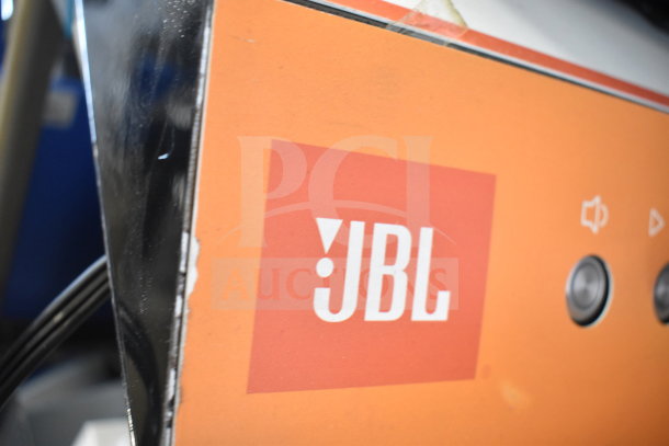 JBL Boombox3 speaker store display, featuring an orange panel with JBL logo. Good condition, minor wear visible.