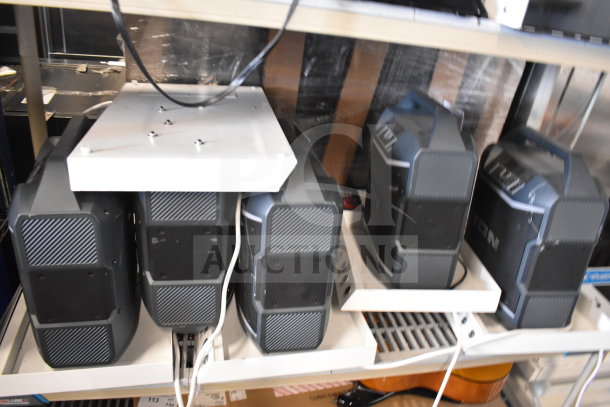 5 Ion speakers on shelves, store display. Good condition, visible wiring, compact design.