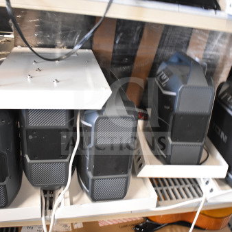 5 Ion speakers on shelves, store display. Good condition, visible wiring, compact design.