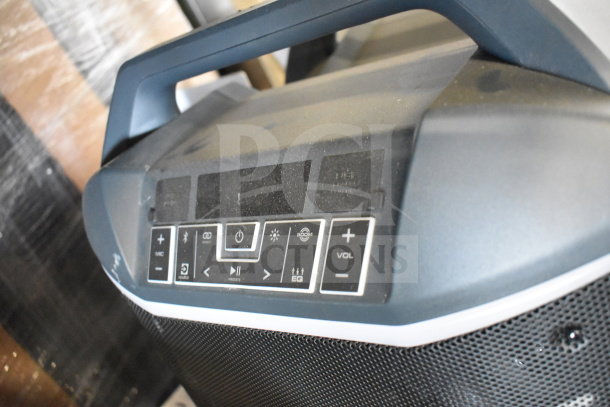 Ion portable speaker with control panel, featuring volume, Bluetooth, and power buttons. Light wear, good condition.