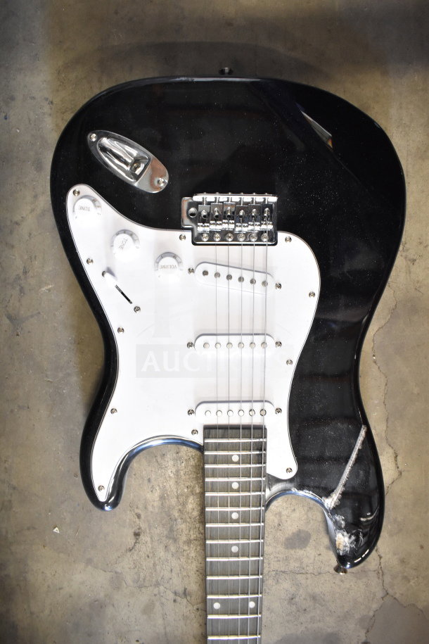 Black Rock Jam electric guitar, white pickguard, and three control knobs. Visible wear on the body, strings intact.