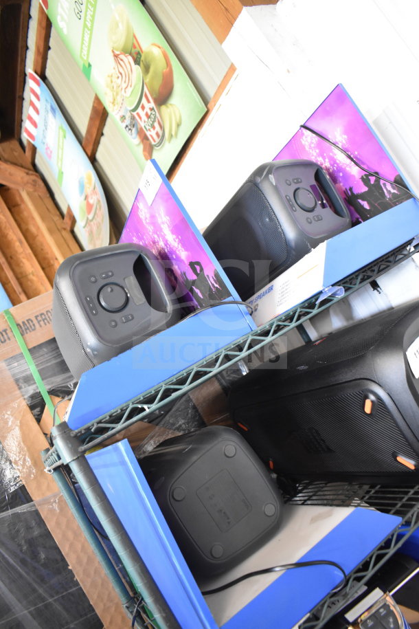 Store display with three Onn medium party speakers, featuring control panels and handles, in good condition. Auction bid opportunity.