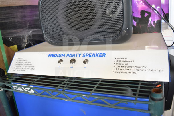 Onn Medium Party Speaker on display. Features Bluetooth, FM radio, IPX7 waterproof, bass boost, USB port, AUX input, carry handle.