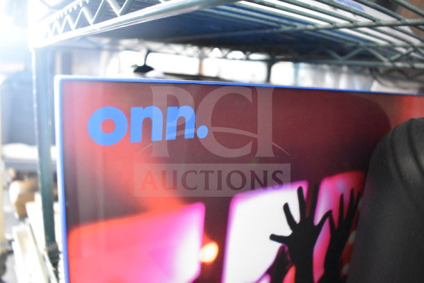 ONN TV screen edge with logo, showing partial image of a vibrant scene. Item part of auction with JBL PartyBox310.