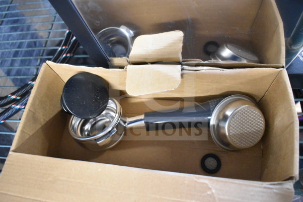 Brand new Nuova Simonelli OSCAR II AD espresso machine in open box, with portafilter and accessories shown.