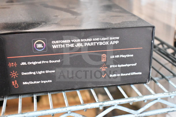 JBL speaker store display box featuring JBL Original Pro Sound, dazzling light show, mic/guitar inputs, 18 HR playtime, IPX4 splashproof.