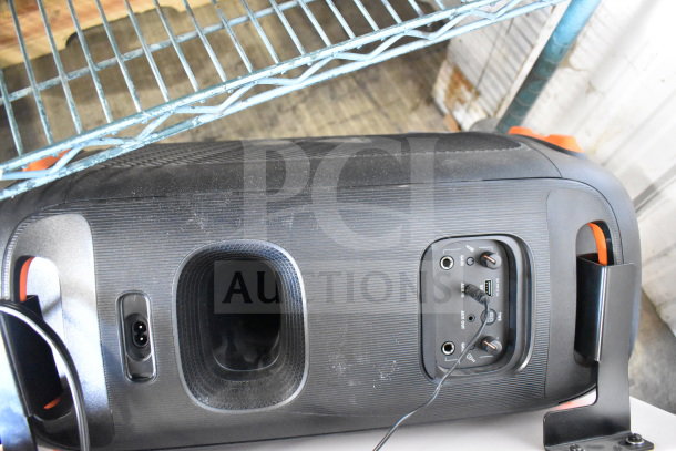 JBL PartyBox 110 speaker on display shelf, showing control panel with inputs and knobs. Slight wear visible on surface.