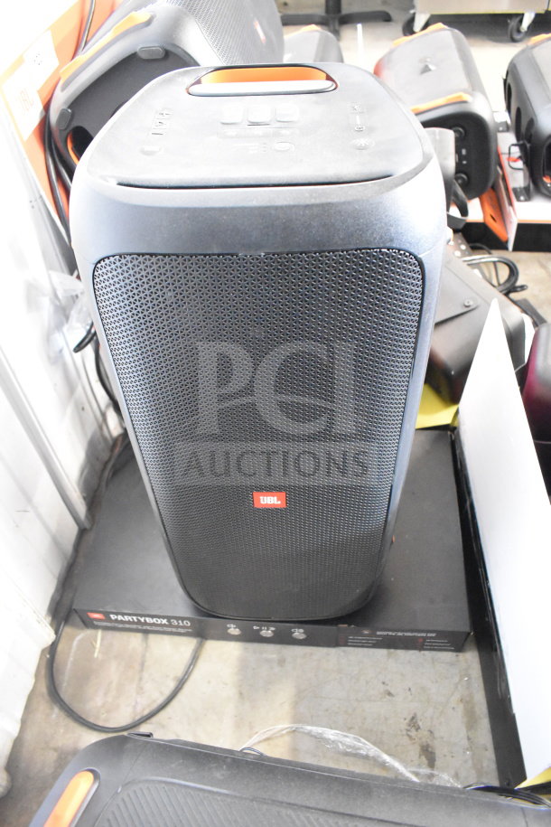 JBL PartyBox 110 speaker in excellent condition on display box. Features front grille, top control panel, and carry handle.