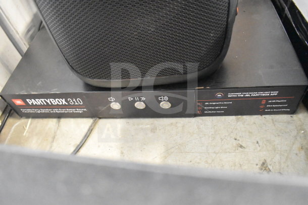 JBL PartyBox 310 speaker on store display, showing controls and features like Pro Sound, light show, and splash-proof design.
