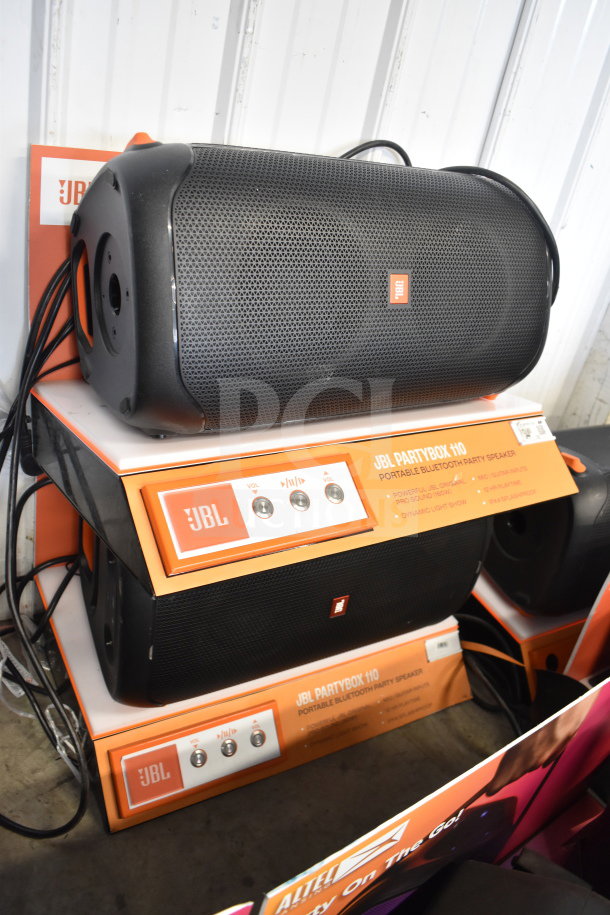 Store display with JBL PartyBox 110 speakers. Features include Bluetooth connectivity, dynamic light show. Excellent condition.