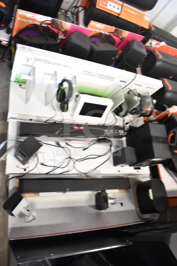3 store displays featuring a gaming screen, headphones, and an LG soundbar. Includes wiring and setup components. Condition: good.