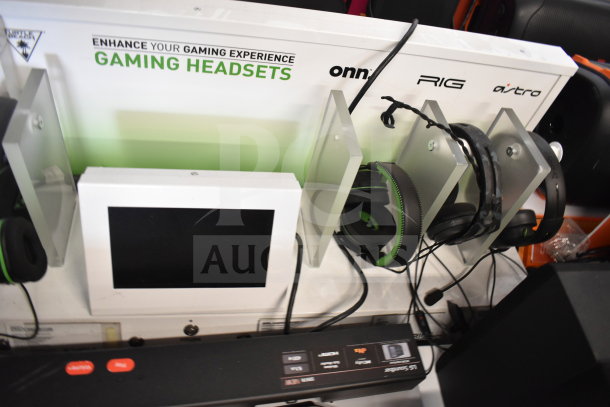 Gaming display with screen, Onn, RIG, and Astro headphones, LG soundbar. Tags read "Enhance Your Gaming Experience."
