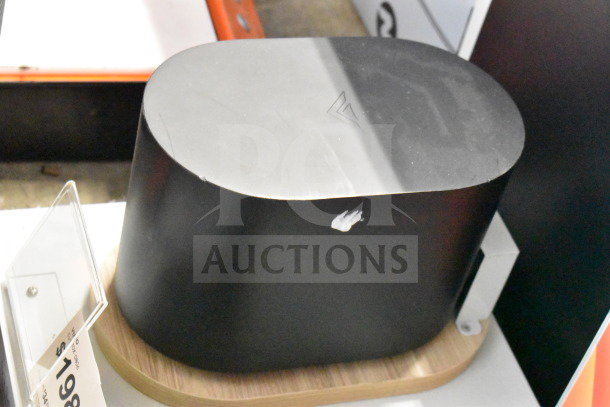 3 Store Display featuring a black LG soundbar on a wooden base. Visible scuff marks; auction price tag nearby.