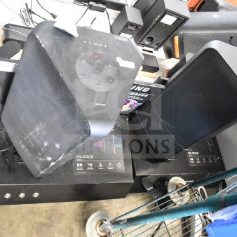 Store display with two Samsung speakers, models MX-ST4CB, with control panels visible, used condition.