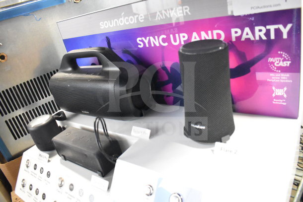 Store display featuring Soundcore Anker speakers, including Flare 2 and Select Pro, with promotional signage.