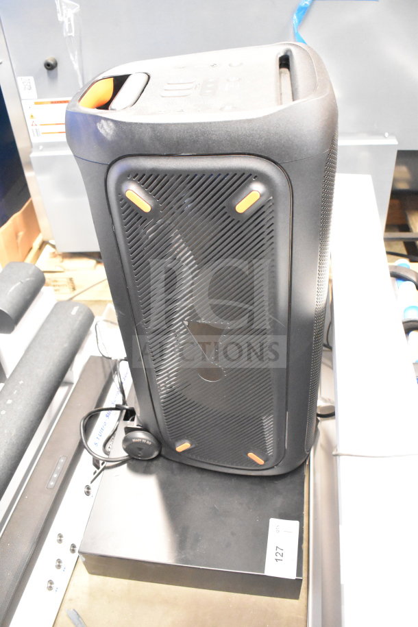 JBL Partybox 310 speaker on store display, black, features illuminated front panel, buttons, handles. Good condition, tag number 127.