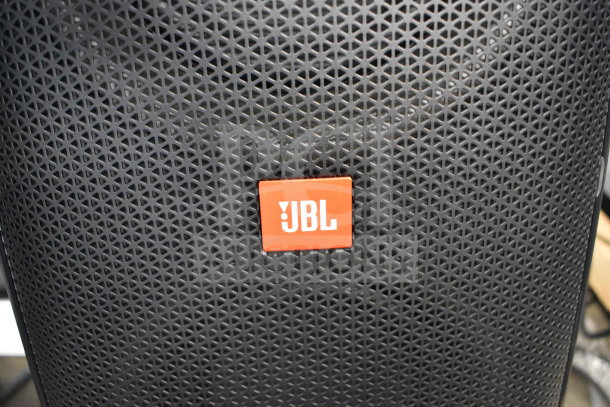 JBL Partybox 310 speaker on display, featuring a black grille with orange JBL logo.