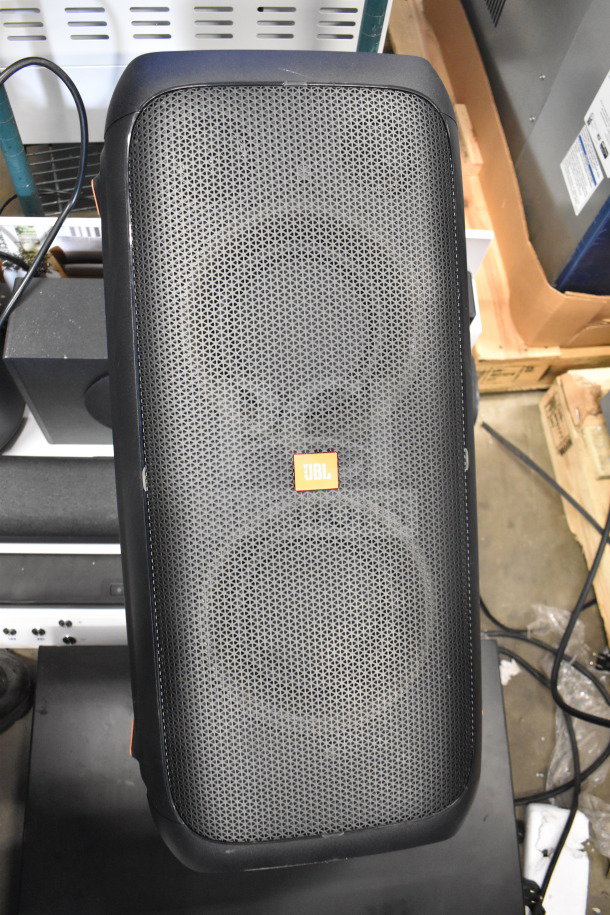 JBL Partybox 310 speaker on store display, features include black grille, rectangular design. Good condition.